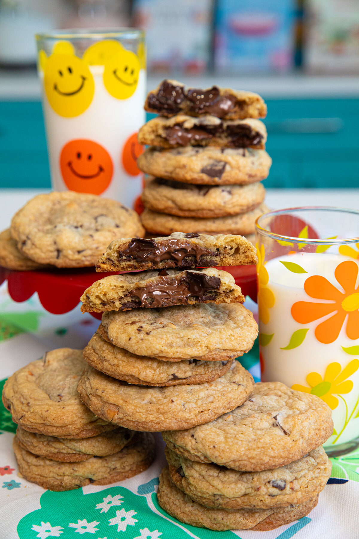 A stack of Nutella Stuffed Hazelnut Chocolate Chip Cookies with a glass of milk
