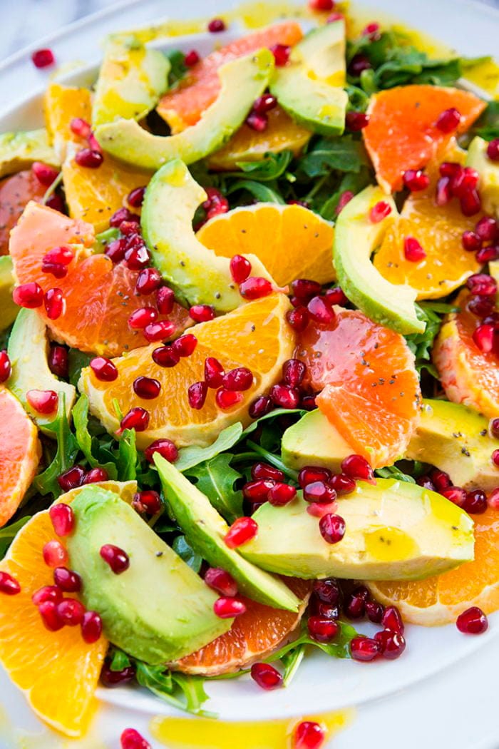 closeup of arugula, slices of orange,avocado,grapefruit and pieces of pomegranate